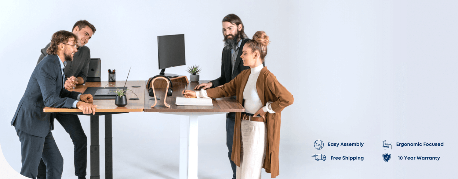 Office team using height adjustable standing desks in modern workspace