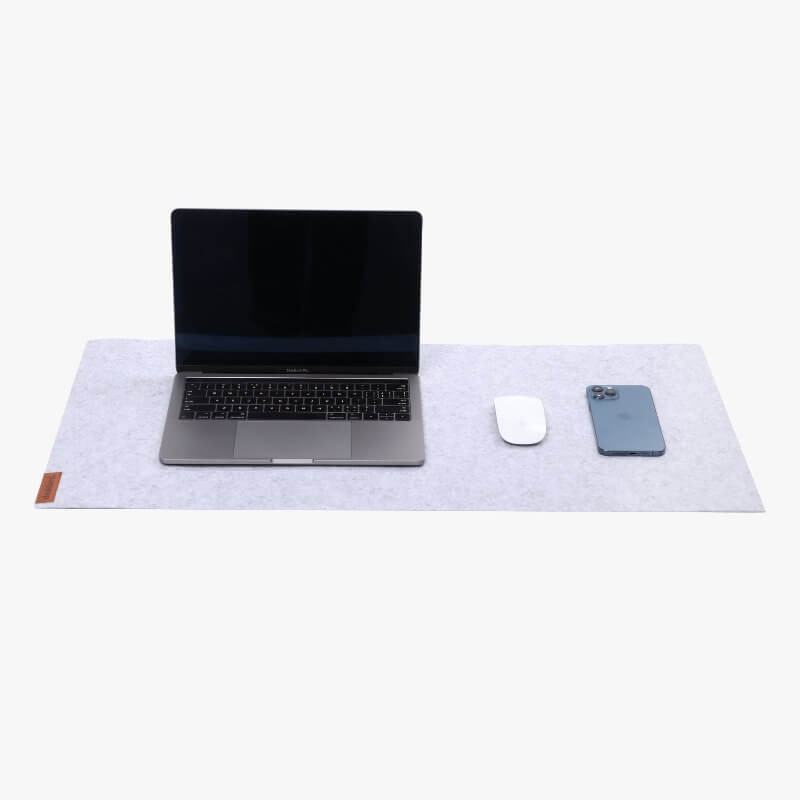 laptop on grey desk pad
