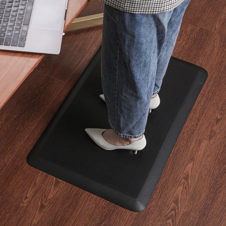 person with heels standing on mat