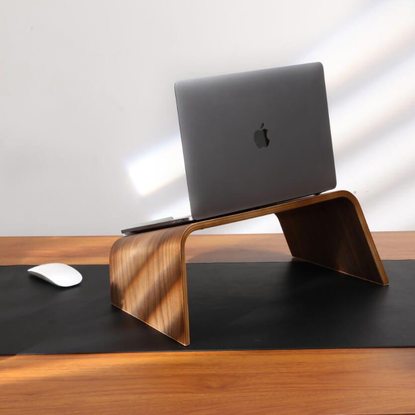 walnut laptop stand on desk pad